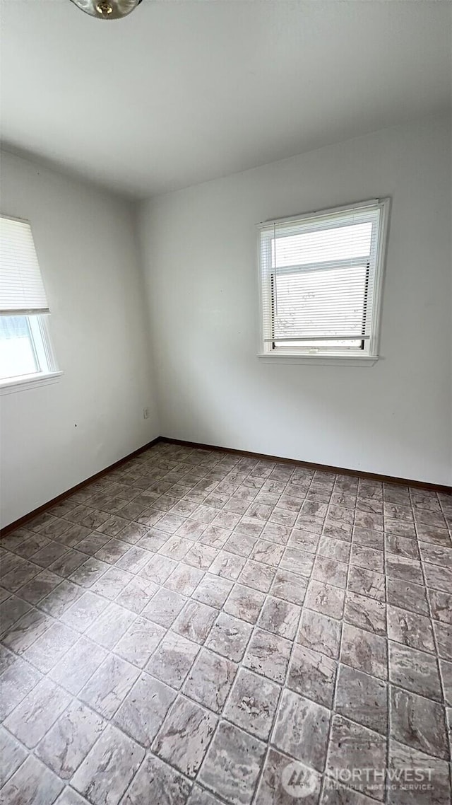 313 N E St, Aberdeen, WA 98520 - empty room with plenty of natural light and baseboards