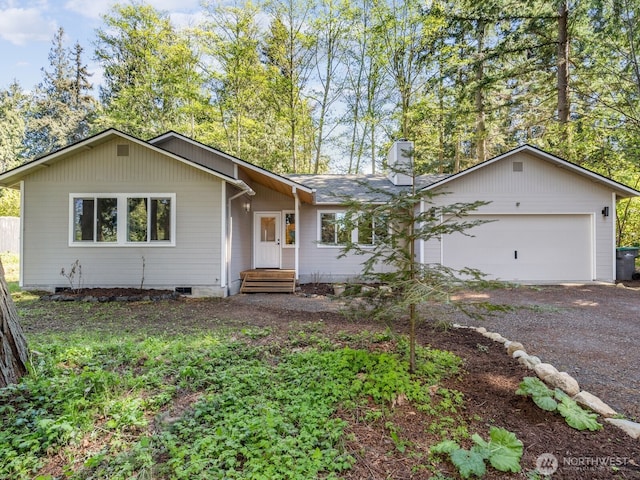 single story home with an attached garage, a chimney, driveway, and crawl space