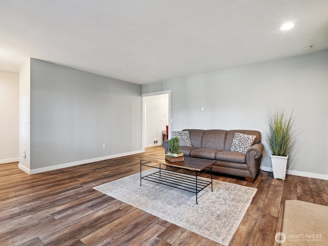 living room featuring baseboards and wood finished floors