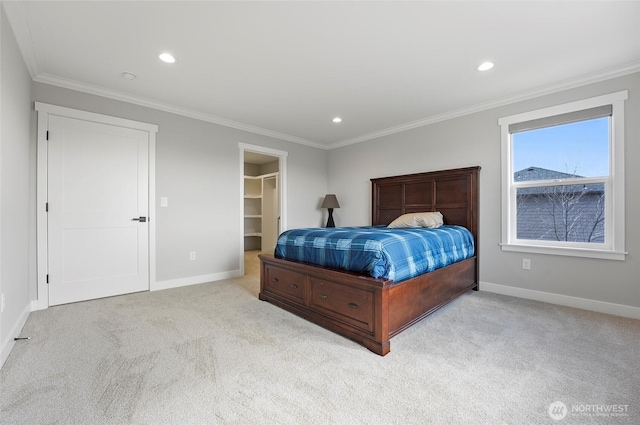 bedroom featuring baseboards, crown molding, a walk in closet, and carpet