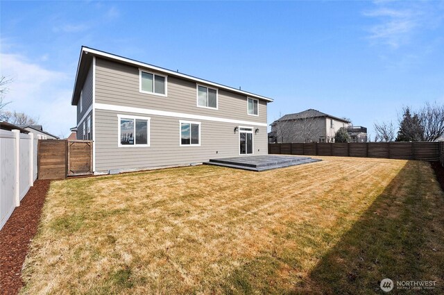 rear view of house featuring a fenced backyard, a yard, and a wooden deck