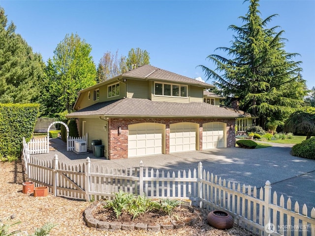 view of front of property with driveway, brick siding, and a garage