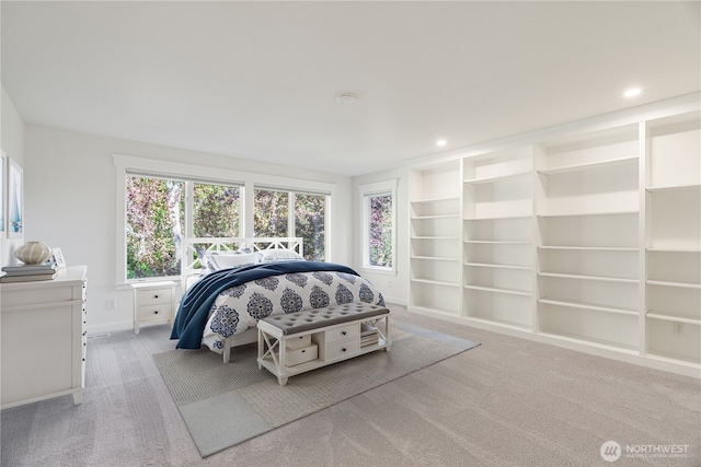 bedroom featuring multiple windows, light colored carpet, recessed lighting, and baseboards
