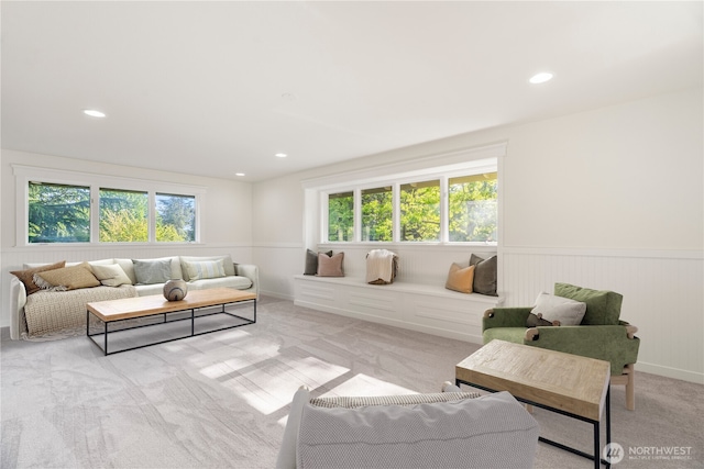 living room with light colored carpet, a wainscoted wall, and recessed lighting