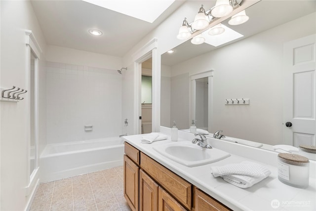 bathroom featuring vanity, bathtub / shower combination, recessed lighting, tile patterned flooring, and a skylight