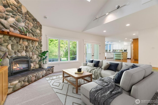 living area featuring a fireplace, baseboards, recessed lighting, and high vaulted ceiling