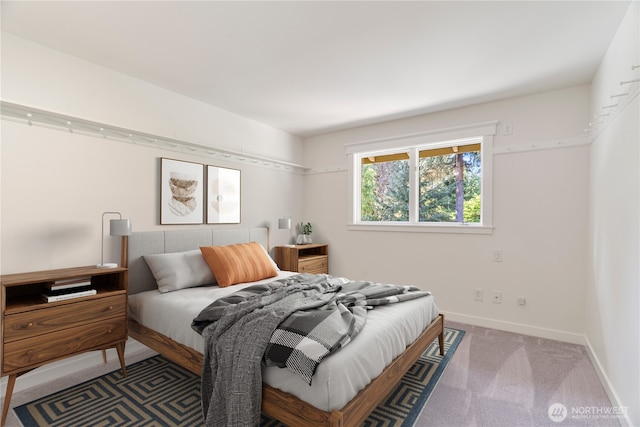 bedroom featuring carpet floors and baseboards