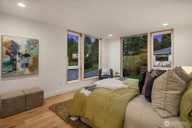 bedroom with recessed lighting, baseboards, and wood finished floors
