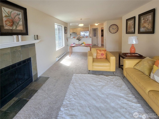 carpeted living area featuring a tiled fireplace, baseboards, and a baseboard radiator