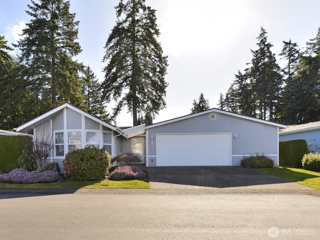 6012 91st Street Ct E, Puyallup, WA 98371 - view of front of property with driveway, stucco siding, and an attached garage