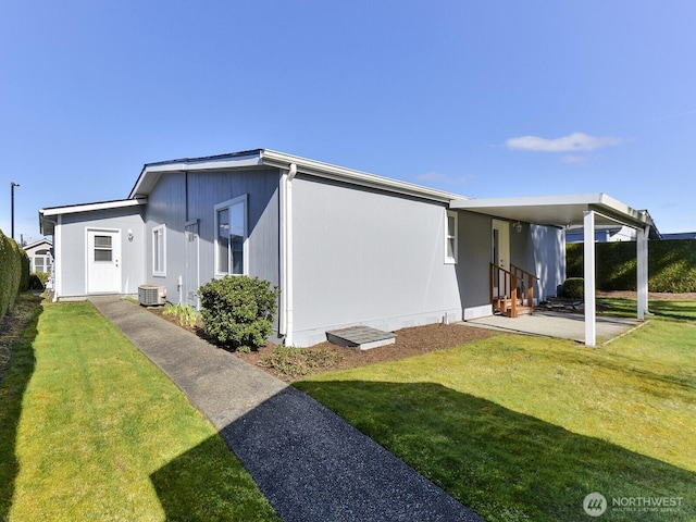 6012 91st Street Ct E, Puyallup, WA 98371 - exterior space with central air condition unit and a front lawn