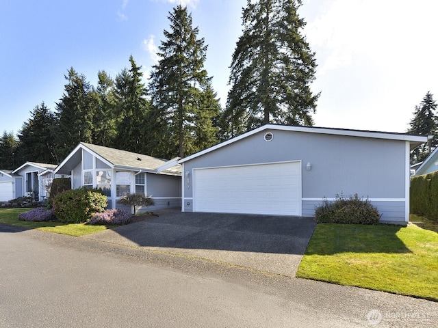 6012 91st Street Ct E, Puyallup, WA 98371 - ranch-style home with an attached garage, aphalt driveway, and a front yard