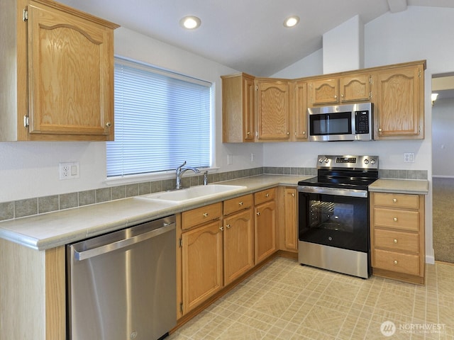 6012 91st Street Ct E, Puyallup, WA 98371 - kitchen with light countertops, lofted ceiling, recessed lighting, a sink, and appliances with stainless steel finishes
