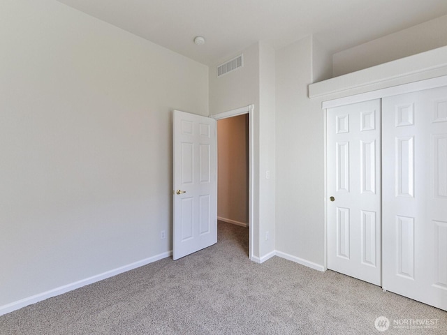 6012 91st Street Ct E, Puyallup, WA 98371 - unfurnished bedroom with baseboards, visible vents, a closet, and light carpet