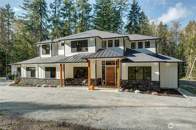 view of front of home featuring a standing seam roof and stone siding