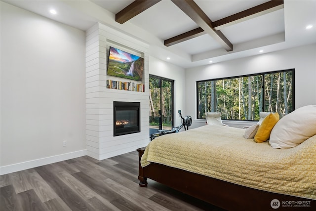 bedroom with recessed lighting, beam ceiling, baseboards, and wood finished floors