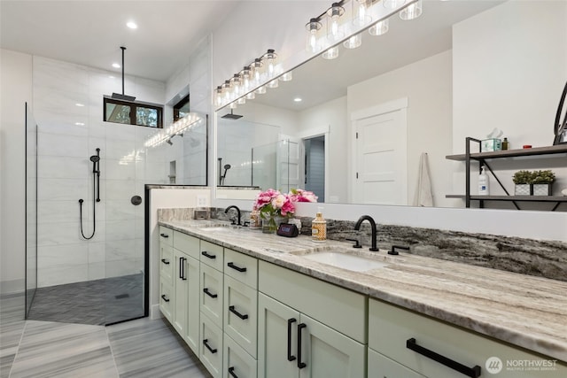 bathroom featuring double vanity, a sink, a tile shower, and recessed lighting