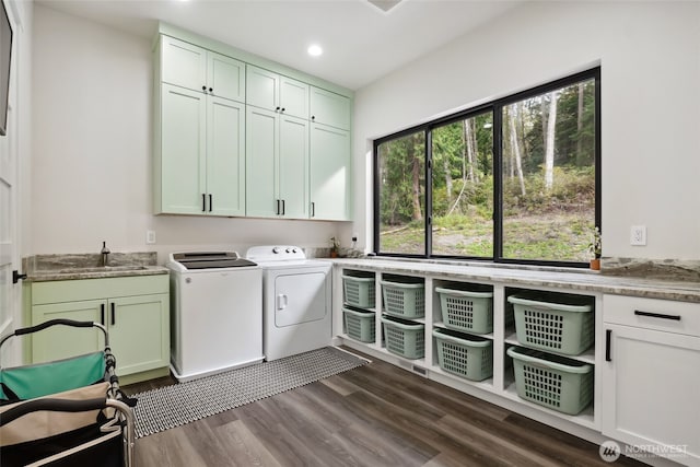 laundry room featuring a sink, washing machine and clothes dryer, dark wood finished floors, cabinet space, and recessed lighting
