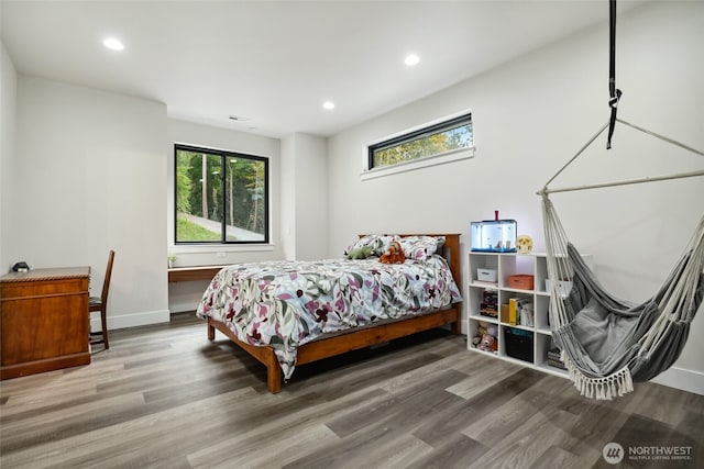 bedroom with recessed lighting, baseboards, visible vents, and wood finished floors