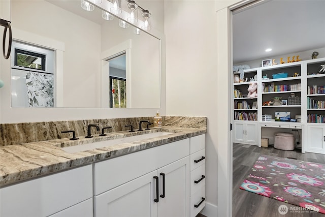full bathroom featuring wood finished floors and vanity