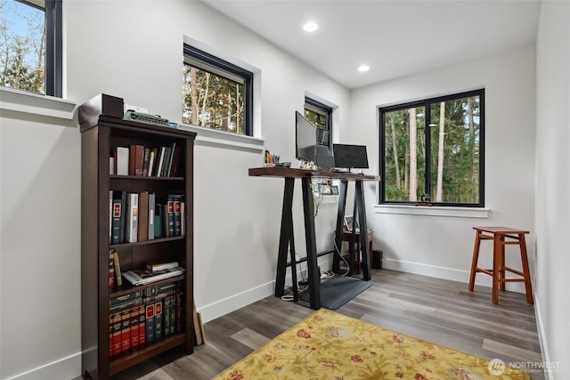 workout room with baseboards, wood finished floors, and recessed lighting