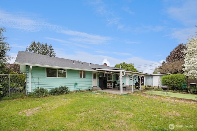 back of house with a patio area, fence, a yard, and a chimney