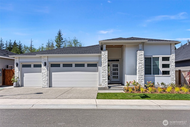 6346 Marymere Rd SW, Port Orchard, WA 98367 - prairie-style house featuring a garage, fence, stone siding, a shingled roof, and concrete driveway