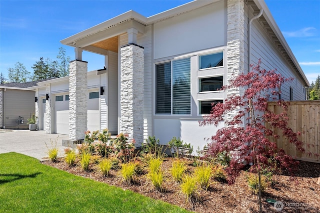 6346 Marymere Rd SW, Port Orchard, WA 98367 - view of side of home with fence, an attached garage, concrete driveway, and a chimney
