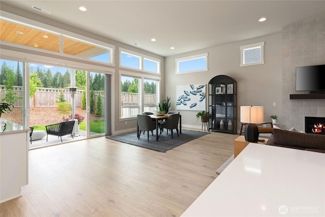 6346 Marymere Rd SW, Port Orchard, WA 98367 - living room with a tiled fireplace, recessed lighting, wood finished floors, and a towering ceiling