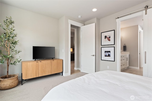 6346 Marymere Rd SW, Port Orchard, WA 98367 - bedroom featuring connected bathroom, recessed lighting, light carpet, and a barn door
