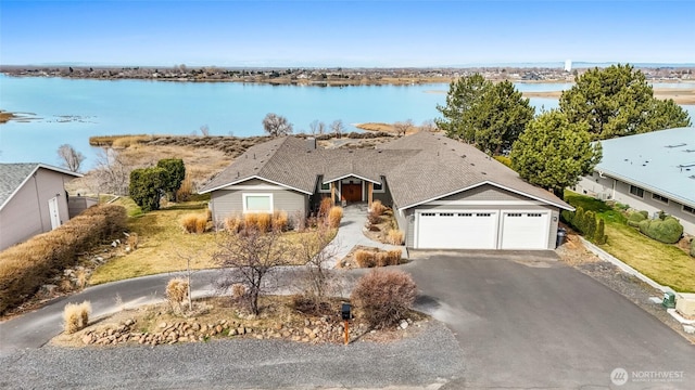 6 Pelican Pl SE, Moses Lake, WA 98837 - view of front of home featuring a water view, driveway, and an attached garage