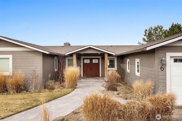6 Pelican Pl SE, Moses Lake, WA 98837 - entrance to property featuring a chimney, a shingled roof, and an attached garage
