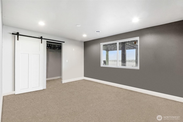 6 Pelican Pl SE, Moses Lake, WA 98837 - unfurnished bedroom with a closet, carpet flooring, a barn door, baseboards, and recessed lighting