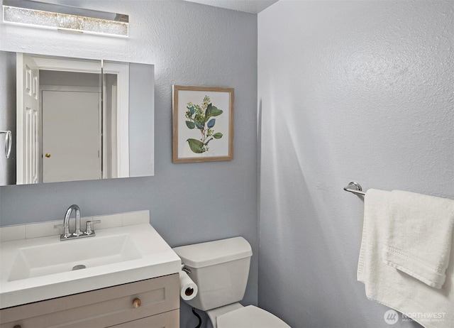15126 NE 67th Pl, Redmond, WA 98052 - half bathroom featuring vanity, a textured wall, and toilet