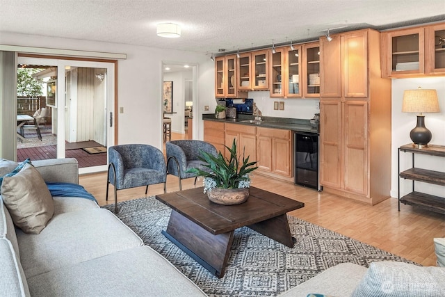 15126 NE 67th Pl, Redmond, WA 98052 - living room with beverage cooler, a textured ceiling, and light wood-style flooring