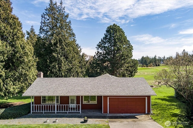 ranch-style home featuring concrete driveway, an attached garage, a front lawn, a porch, and a chimney