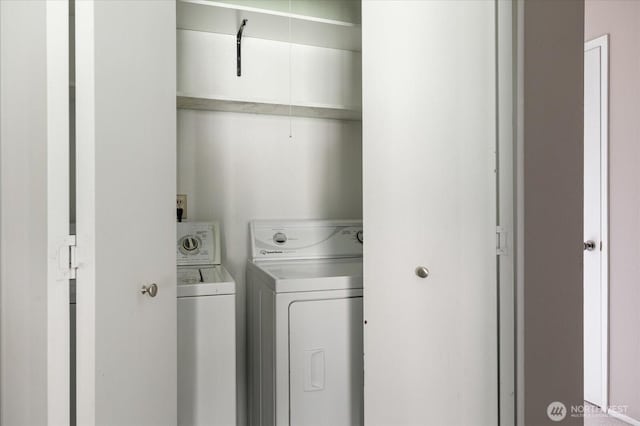 laundry room with washing machine and clothes dryer and laundry area