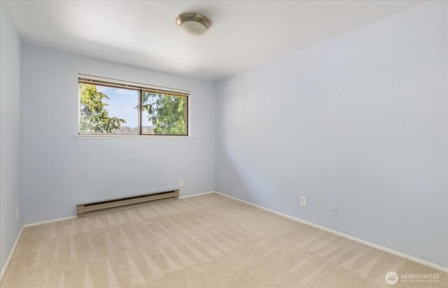 carpeted spare room with baseboards and baseboard heating