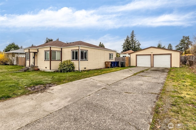 861 S 72nd St, Tacoma, WA 98408 - view of property exterior featuring a detached garage, an outbuilding, fence, and a lawn