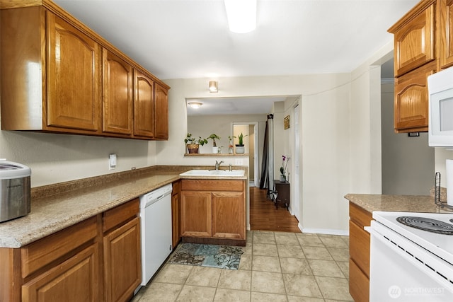 861 S 72nd St, Tacoma, WA 98408 - kitchen featuring light tile patterned flooring, a peninsula, white appliances, a sink, and brown cabinetry