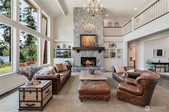 1220 Madrona Beach Rd NW, Olympia, WA 98502 - living area with visible vents, a notable chandelier, a fireplace, beamed ceiling, and high vaulted ceiling