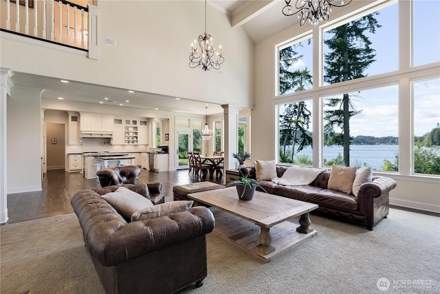 1220 Madrona Beach Rd NW, Olympia, WA 98502 - living area with decorative columns, visible vents, a water view, a chandelier, and baseboards