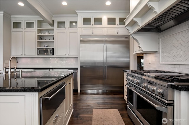 1220 Madrona Beach Rd NW, Olympia, WA 98502 - kitchen featuring white cabinets, open shelves, wall chimney exhaust hood, built in appliances, and dark wood-type flooring