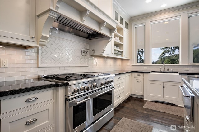 1220 Madrona Beach Rd NW, Olympia, WA 98502 - kitchen featuring glass insert cabinets, premium range hood, dark wood-type flooring, range with two ovens, and a sink