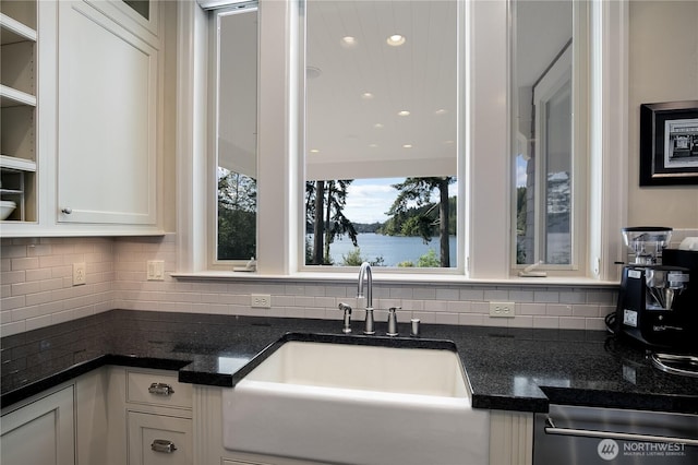 1220 Madrona Beach Rd NW, Olympia, WA 98502 - kitchen featuring a sink, backsplash, white cabinets, and a water view