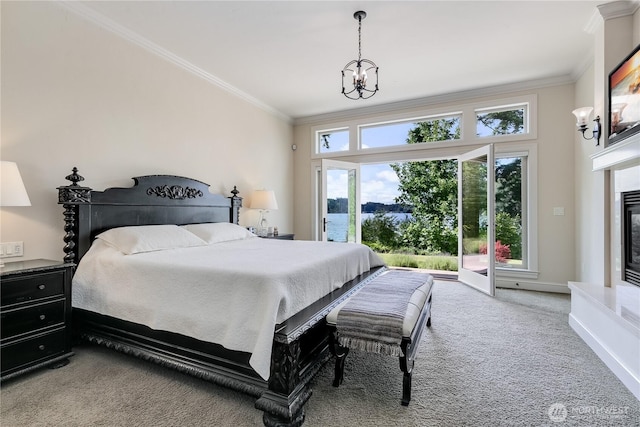 1220 Madrona Beach Rd NW, Olympia, WA 98502 - bedroom featuring an inviting chandelier, ornamental molding, carpet, access to exterior, and a glass covered fireplace