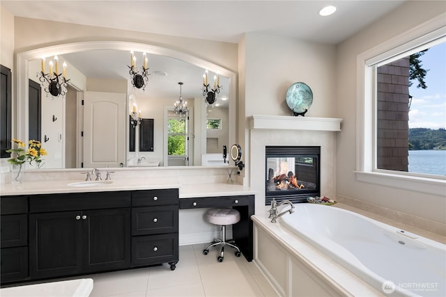 1220 Madrona Beach Rd NW, Olympia, WA 98502 - bathroom featuring vanity, an inviting chandelier, tile patterned floors, a multi sided fireplace, and a bath
