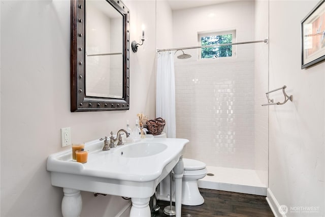 1220 Madrona Beach Rd NW, Olympia, WA 98502 - full bathroom featuring toilet, a stall shower, and wood finished floors
