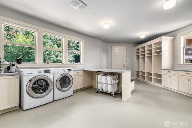 1220 Madrona Beach Rd NW, Olympia, WA 98502 - laundry area featuring washer and dryer, visible vents, and cabinet space