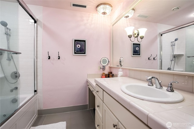 1220 Madrona Beach Rd NW, Olympia, WA 98502 - bathroom featuring shower / bath combination with glass door, vanity, baseboards, tile patterned flooring, and visible vents